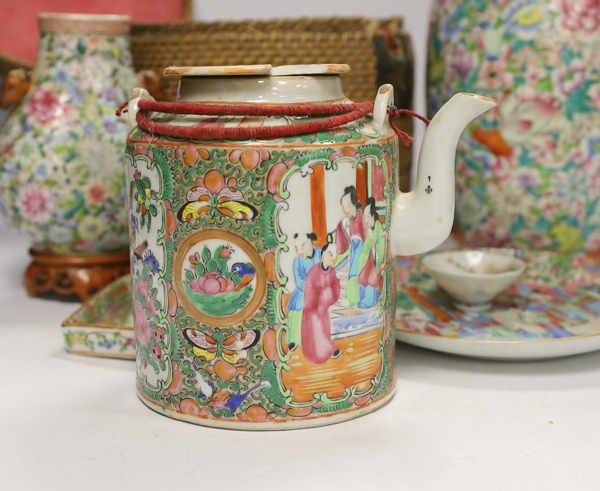 Two Chinese enamelled porcelain Millefleur vases, one with Qianlong Mark, both late 19th/early 20th century, together with two Chinese famille rose dishes and a similar basket cased tea kettle